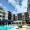 pool in front of a building with a blue umbrella