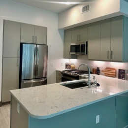 Sleek. Bright. Beautiful. kitchen with an island fridge and cabinets