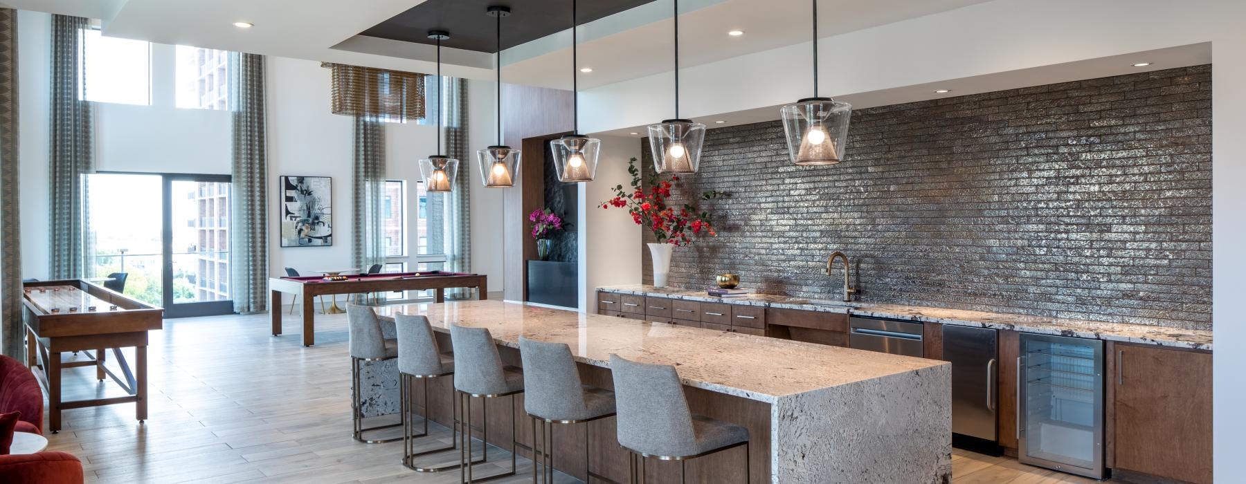 Settle into comfort at Chelsea Museum District a kitchen with a bar and chairs