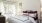 a bed with red and white pillows