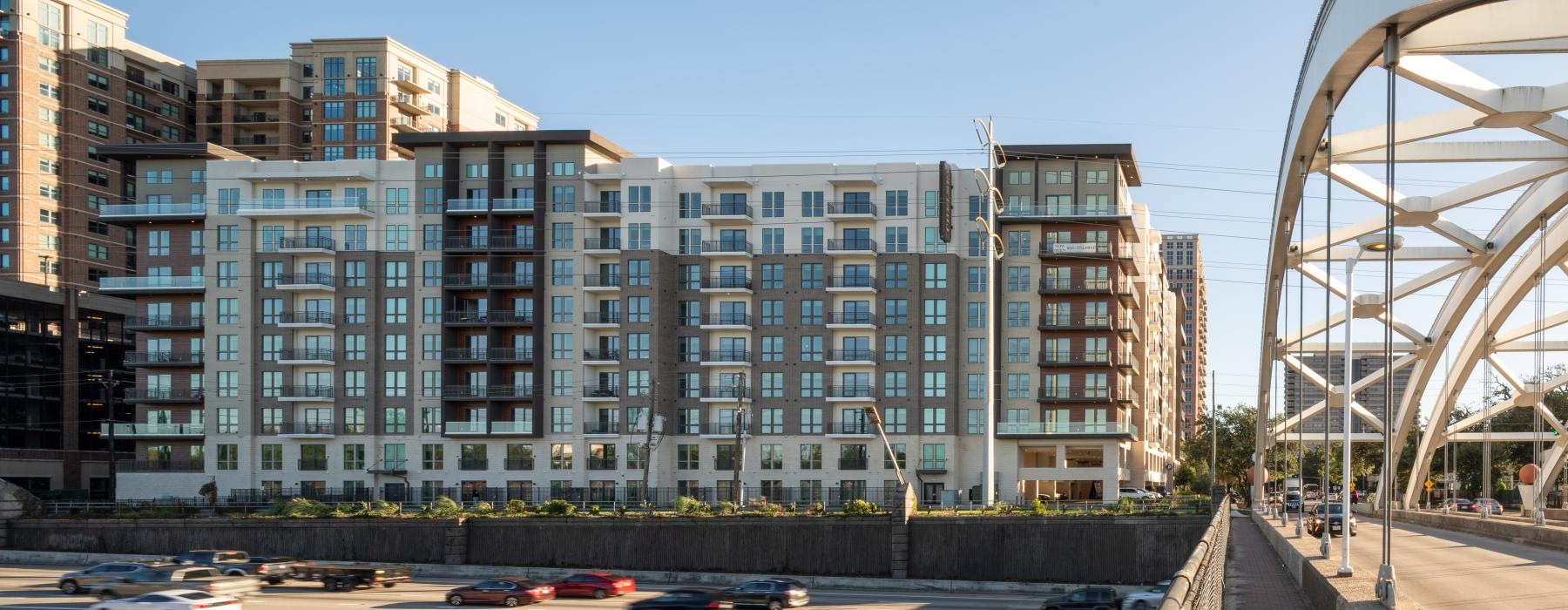 a large building with many windows next to a bridge