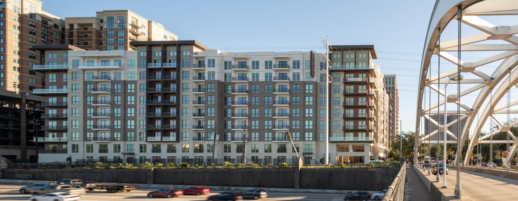 a large building with many windows next to a bridge